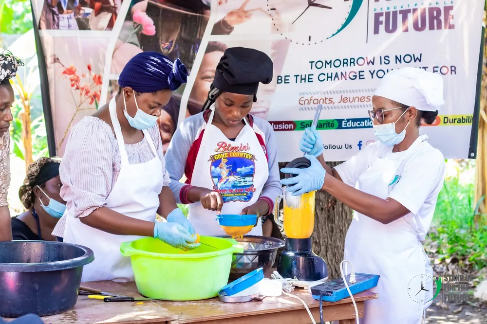 Women preparing food at a StandUp livelihoods activity